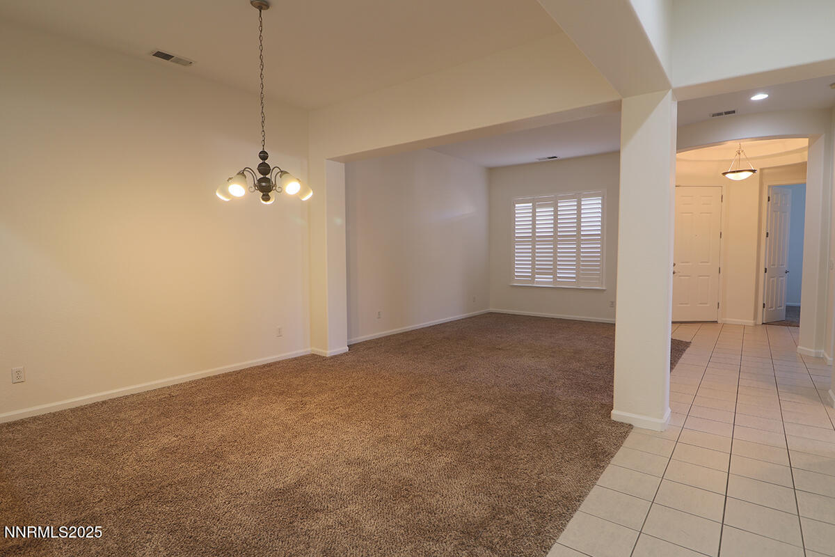 1692 Broadstone Way Reno, NV 89521 - Photo 6 of 31 a view of an empty room with window and wooden floor