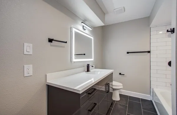 a bathroom with a sink toilet and shower