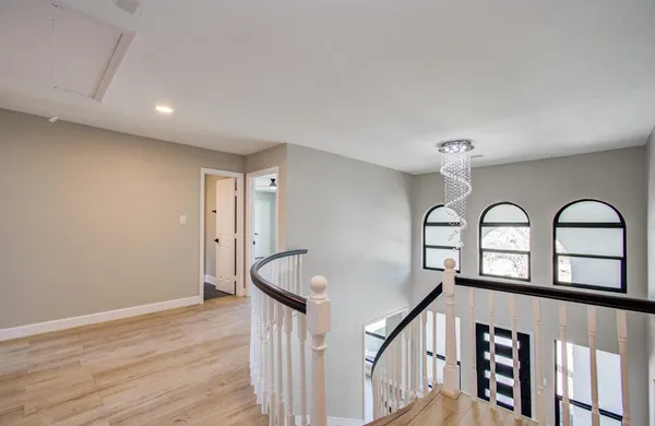 a view of wooden floor in a hall with a window