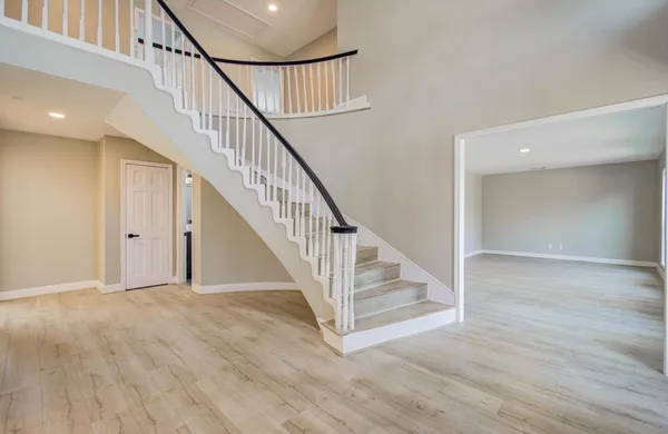 a view of staircase with white walls and a window