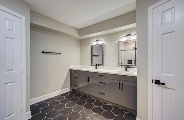a spacious bathroom with a double vanity sink mirror and