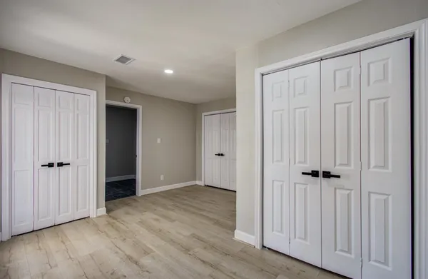 an empty room with wooden floor