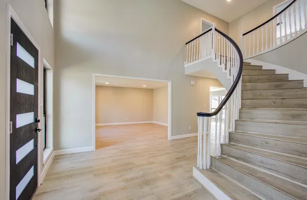 a view of entryway and hall with wooden floor