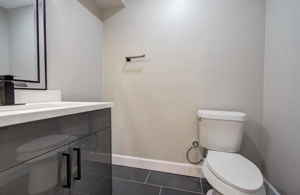 a white toilet sitting next to a bathroom sink