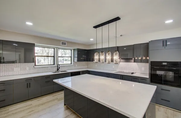 a kitchen with stainless steel appliances a sink and stove