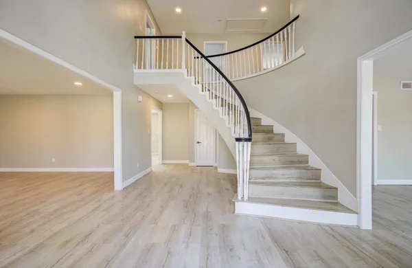 a view of entryway and hall with wooden floor
