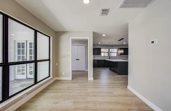 a view of kitchen with refrigerator and wooden floor