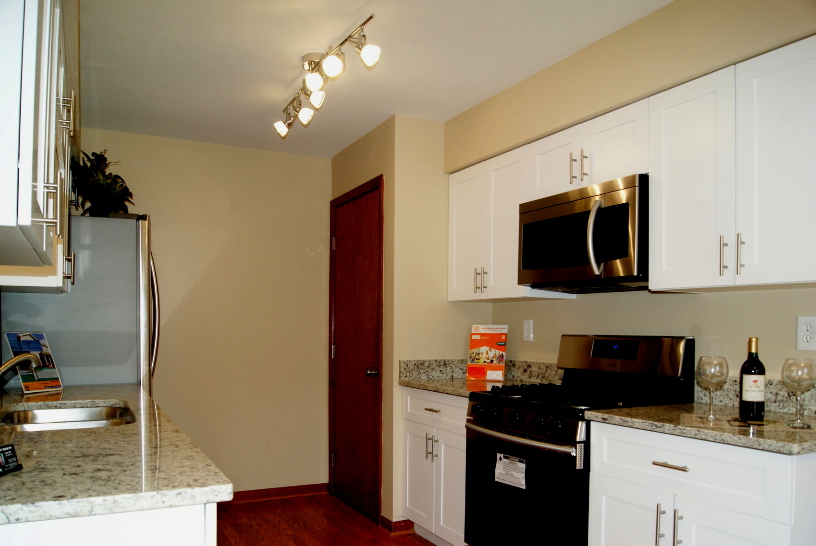 264 Circlegate Road New Lenox, IL 60451 - Photo 9 of 28 a kitchen with stainless steel appliances granite countertop a refrigerator and a stove top oven