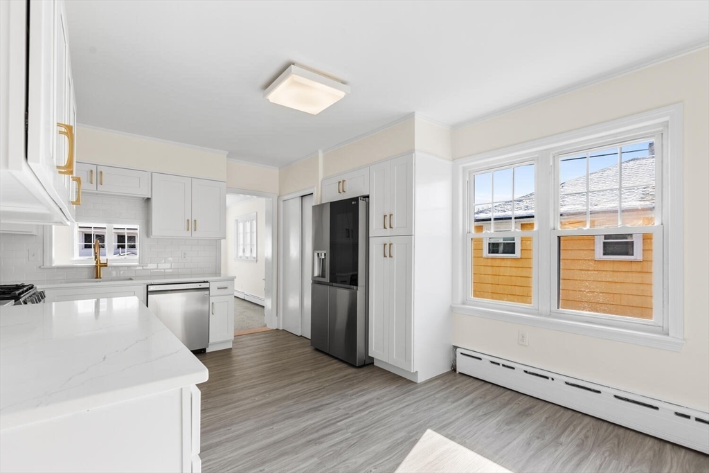 16 York Avenue Watertown, MA 02472 - Photo 11 of 34 a kitchen with stainless steel appliances granite countertop a refrigerator and a sink
