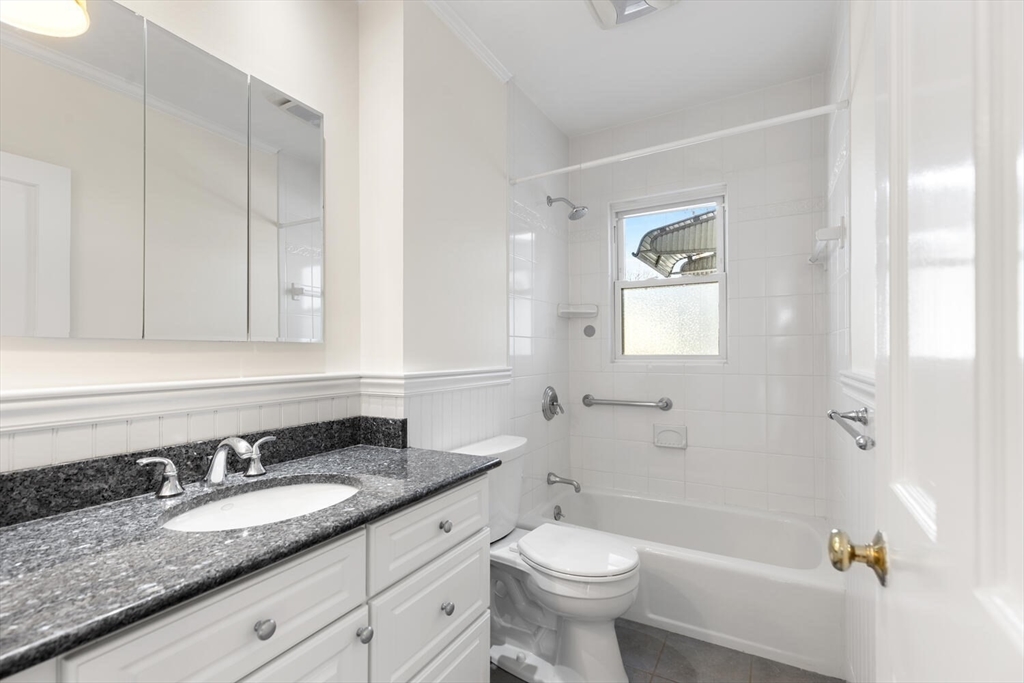 16 York Avenue Watertown, MA 02472 - Photo 19 of 34 a bathroom with a granite countertop sink toilet and shower
