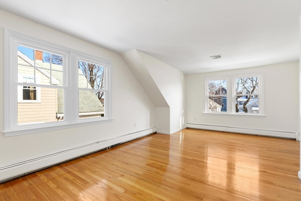 16 York Avenue Watertown, MA 02472 - Photo 20 of 34 a view of an empty room with window and wooden floor