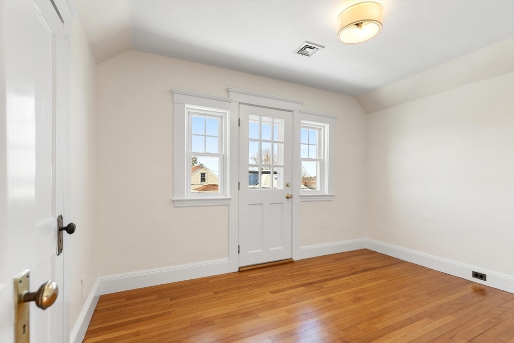 16 York Avenue Watertown, MA 02472 - Photo 22 of 34 an empty room with wooden floor and windows