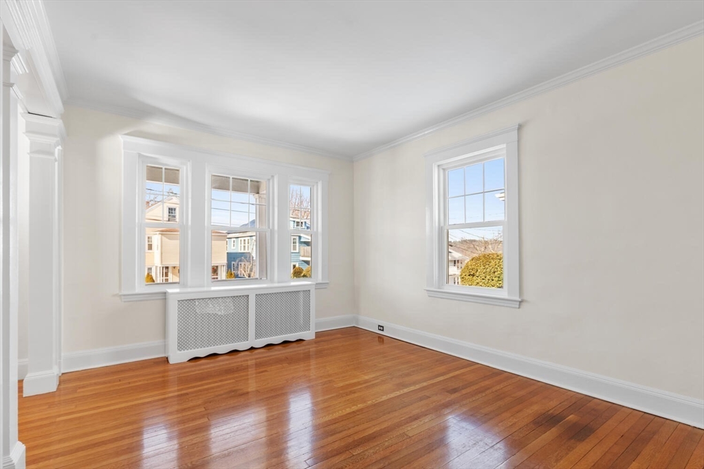 16 York Avenue Watertown, MA 02472 - Photo 6 of 34 an empty room with windows and wooden floor