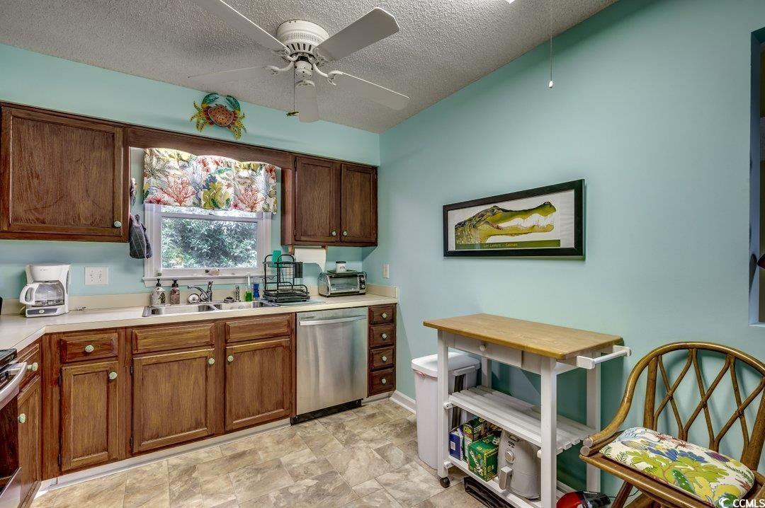 4999 Highway 17 Business, Unit 308E Murrells Inlet, SC 29576 - Photo 2 of 40 Kitchen featuring a ceiling fan, a sink, stainless steel appliances.