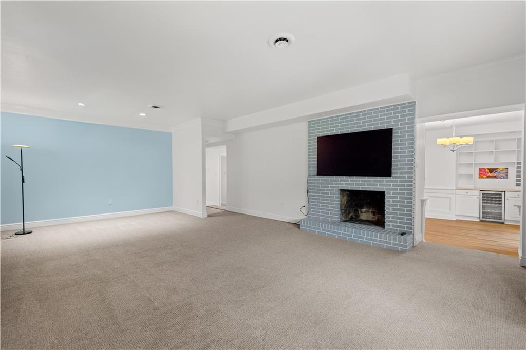 5922 Howe Street, Unit 204 Pittsburgh, PA 15232 - Photo 11 of 42 A cozy fireplace anchors the living area and creates an inviting place to unwind after a day in the city.