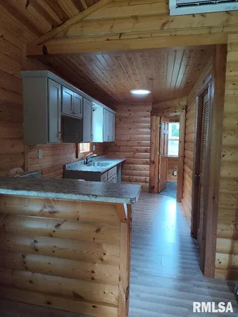 a kitchen with a refrigerator and a sink