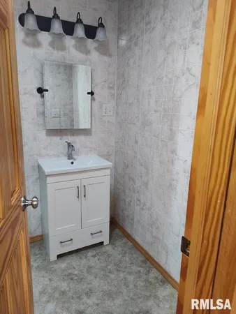 a bathroom with a sink and a mirror