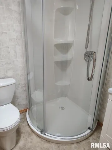 a bathroom with a toilet and shower