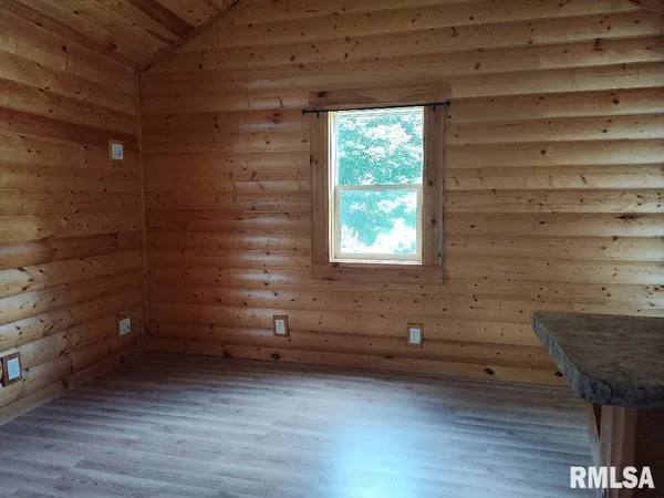 a view of a hardwood floor and a window