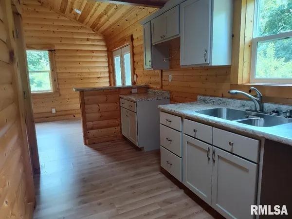 a kitchen with sink and cabinets