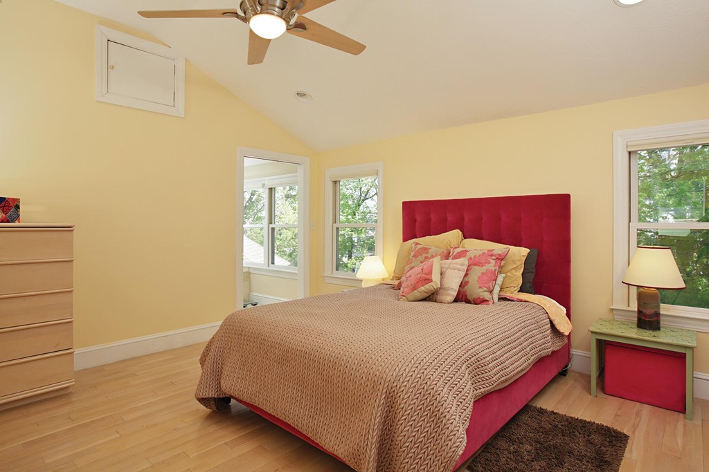 70 Longfellow Road Newton, MA 02462 - Photo 6 of 7 a bedroom with a large bed and a chandelier