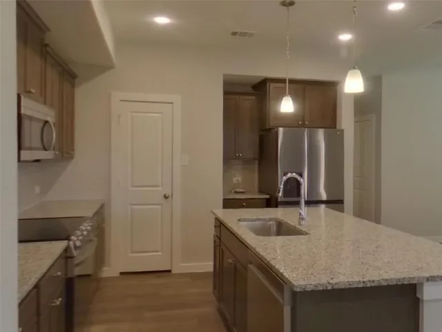 a kitchen with a sink a counter space and a sink