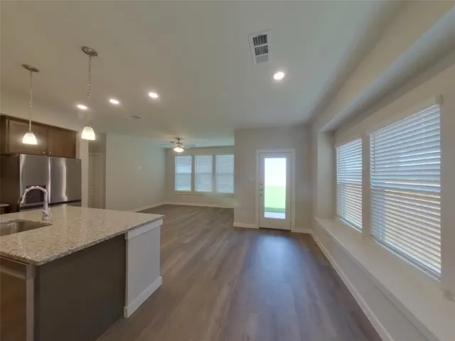 a kitchen with stainless steel appliances granite countertop a sink and a stove