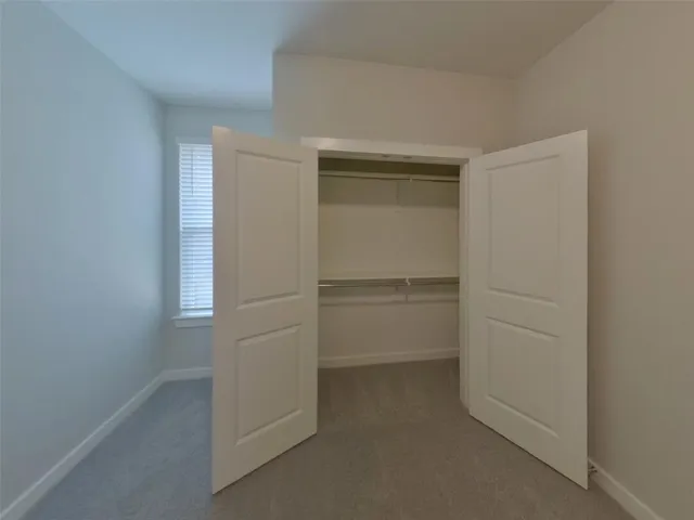 a view of a swimming pool with lawn chairs and plants