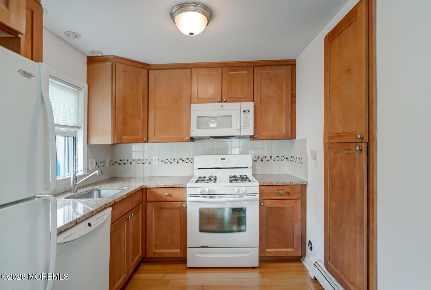 19 Shore Way Lavallette, NJ 08735 - Photo 13 of 38 a kitchen with a stove top oven sink and cabinets