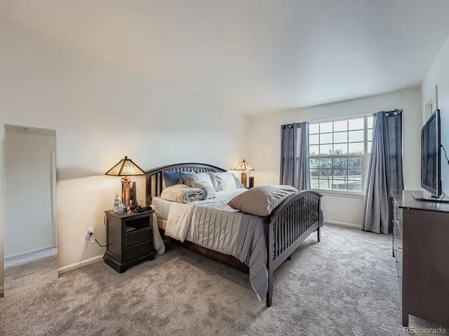 a bedroom with bed and a tv