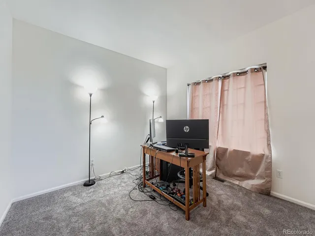 a living room with furniture a flat screen tv and a window