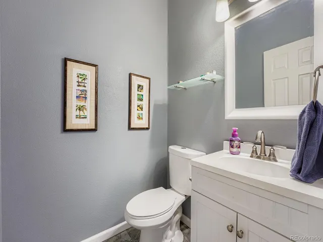 a bathroom with a toilet a sink and a mirror