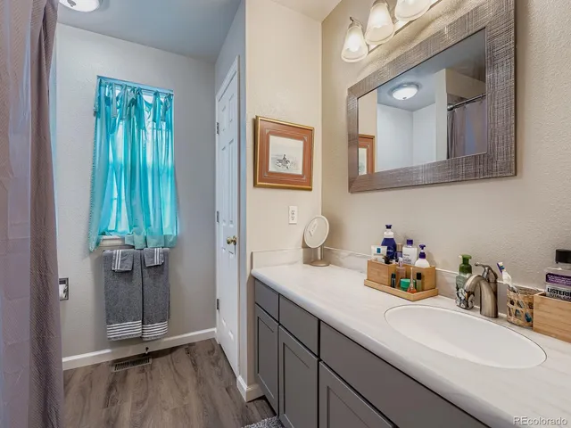 a bathroom with a sink a mirror and vanity