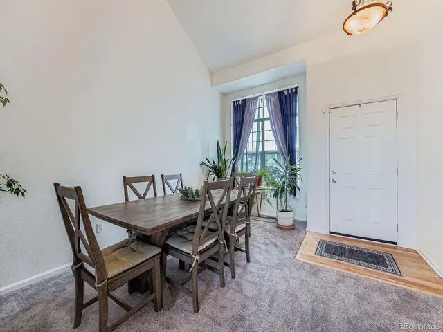 a dining room with furniture and window