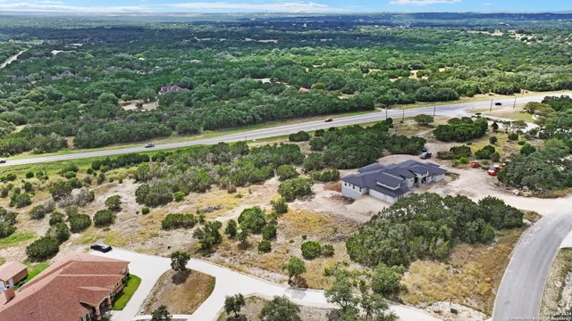 an aerial view of a house with a yard