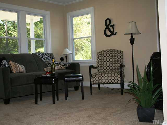 735 Colonial Drive Raleigh, NC 27603 - Photo 4 of 6 Large living room with new paint, new carpet, new moldings, new lighting. Den/Family/Great Room
