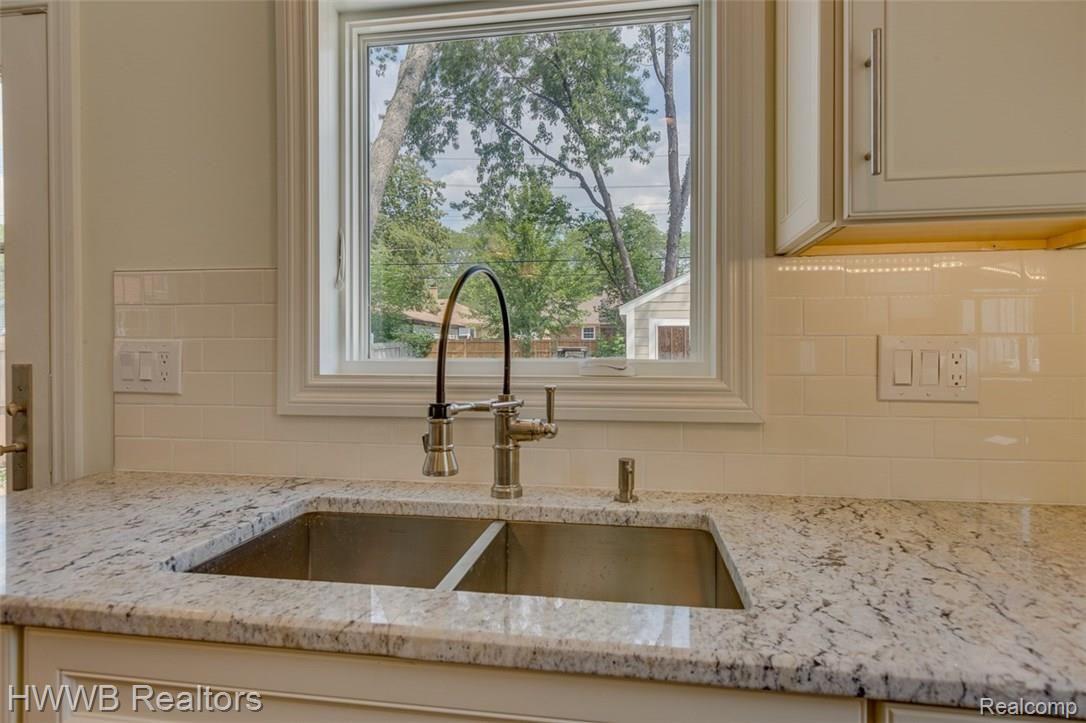 2279 Pembroke Road Birmingham, MI 48009 - Photo 12 of 29 Kitchen sink with a view! Under counter lighting adds to the beauty of the cabinets and the granite