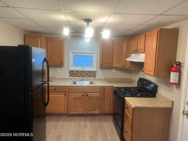a kitchen with stainless steel appliances a sink stove and refrigerator
