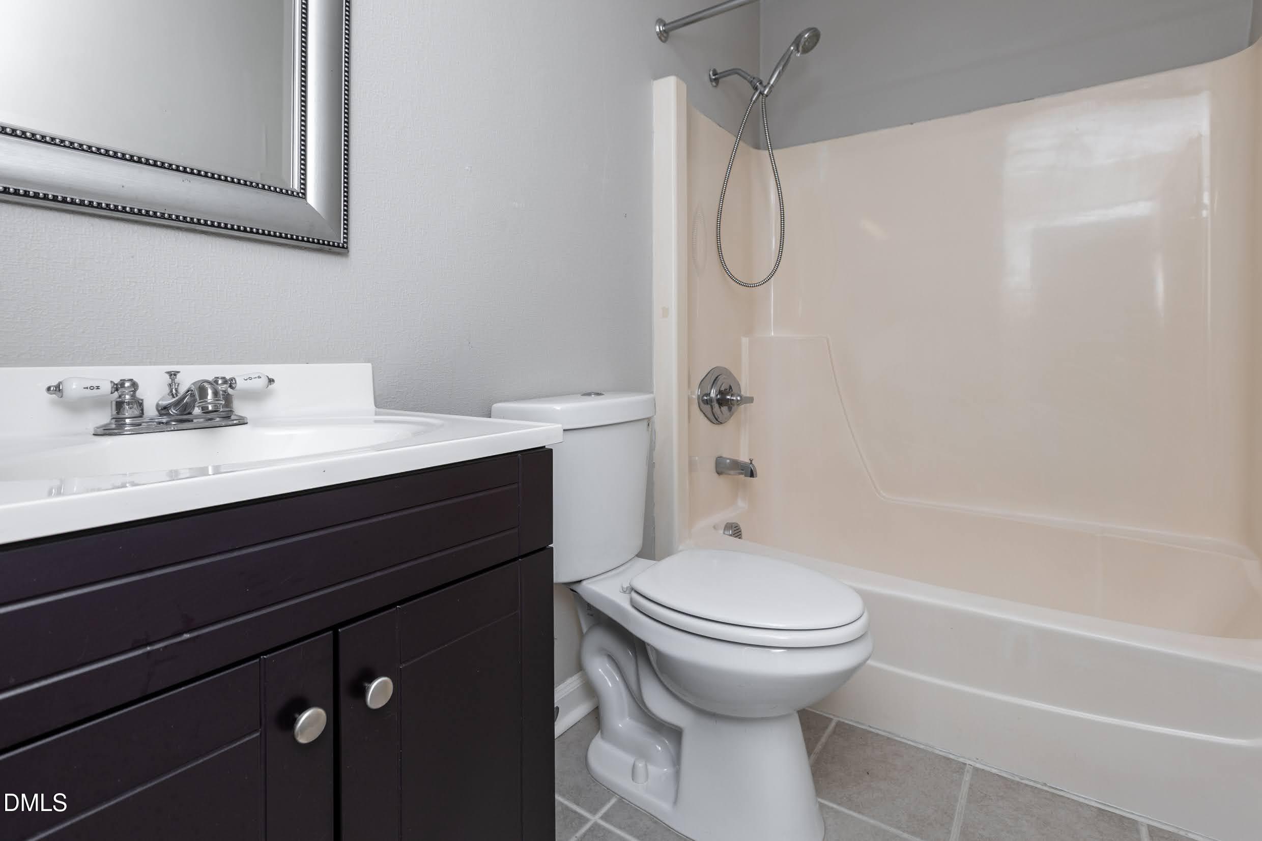 5036 Flint Ridge Place Raleigh, NC 27609 - Photo 20 of 21 a bathroom with a sink a toilet and a bathtub
