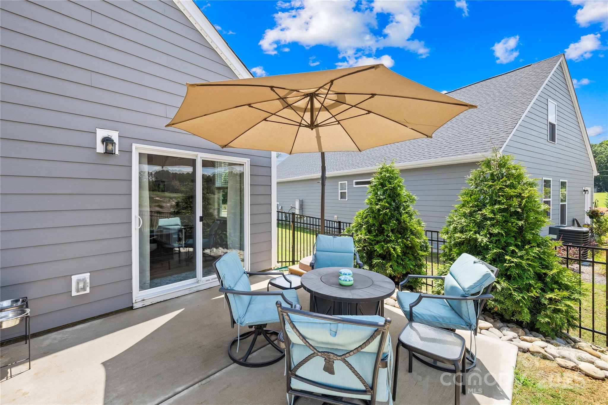 3610 Whitney Way, Unit 2 Terrell, NC 28682 - Photo 4 of 16 a view of a patio with table and chairs under an umbrella