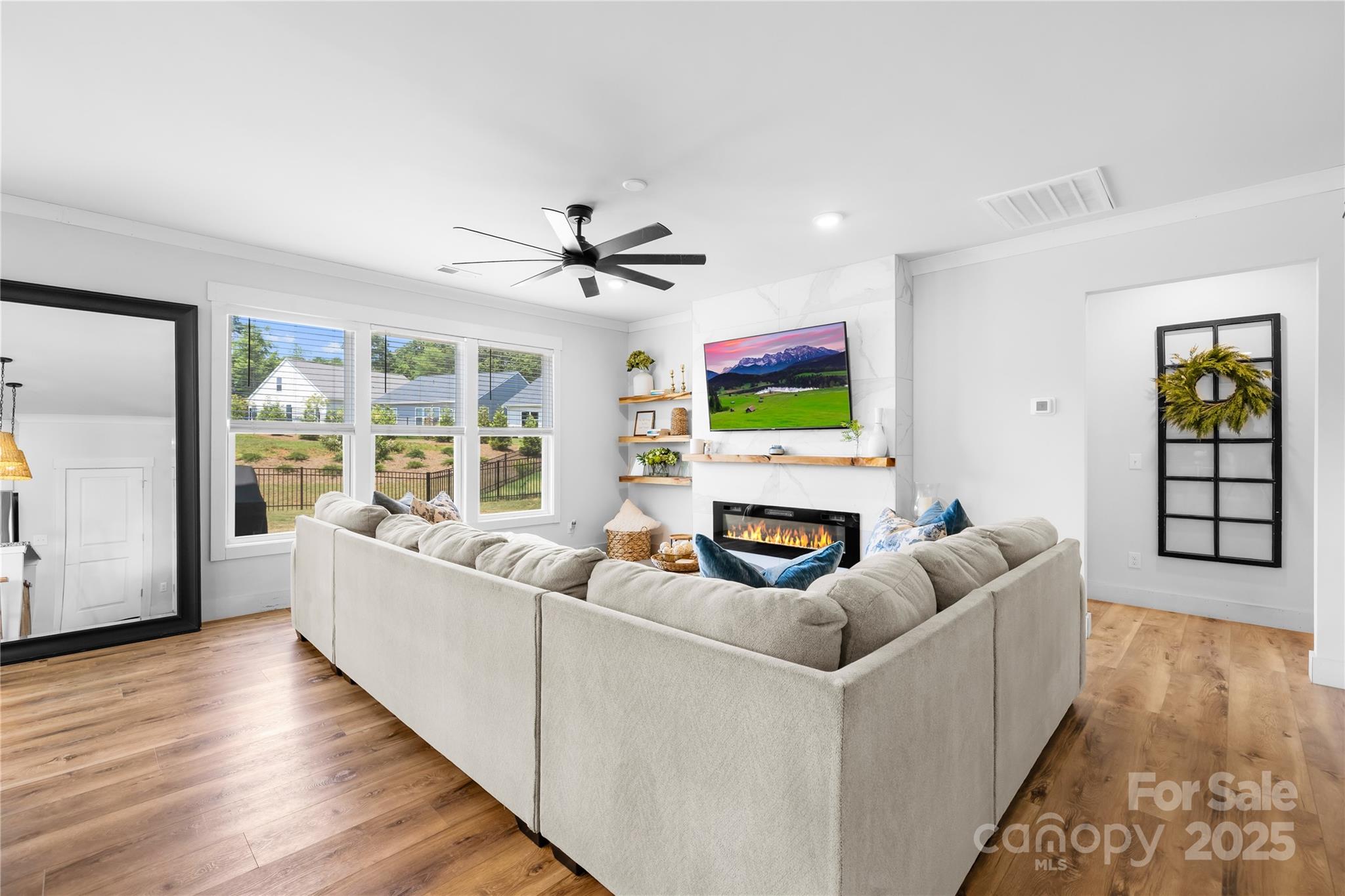 3610 Whitney Way, Unit 2 Terrell, NC 28682 - Photo 6 of 16 a living room with furniture a fireplace and a flat screen tv