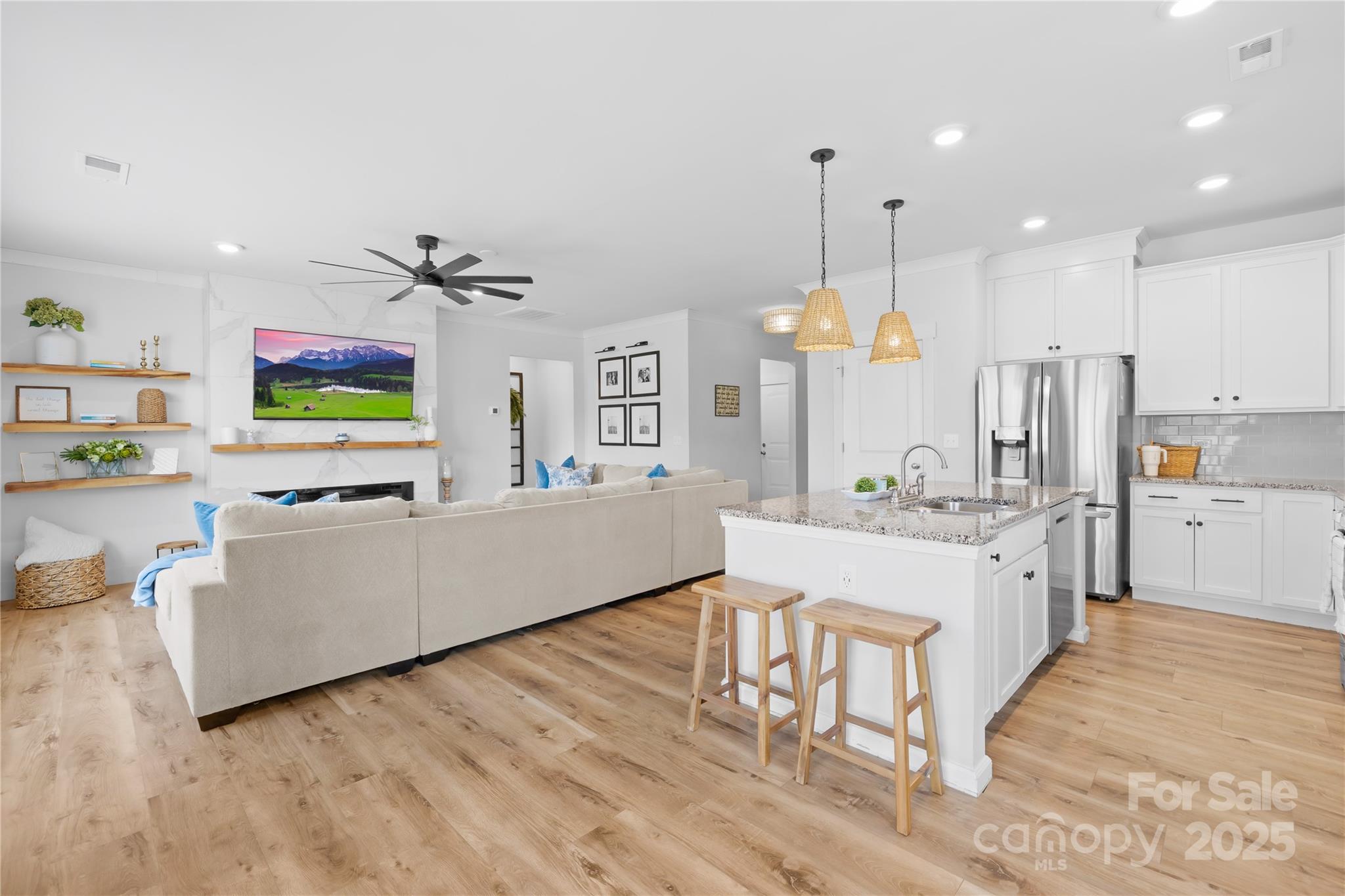 3610 Whitney Way, Unit 2 Terrell, NC 28682 - Photo 8 of 16 a large living room with stainless steel appliances granite countertop furniture a fireplace a flat screen tv and a chandelier