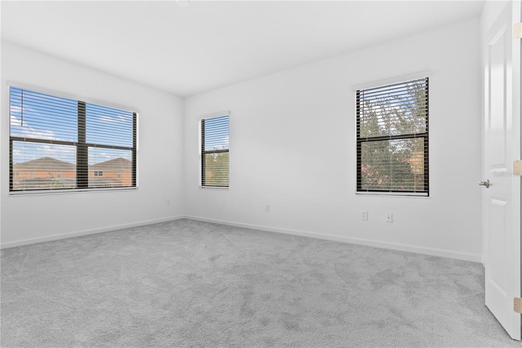 1205 Butterfly Orchid Road Davenport, FL 33837 - Photo 18 of 69 an empty room with windows