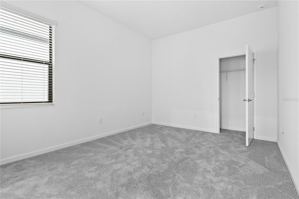 1205 Butterfly Orchid Road Davenport, FL 33837 - Photo 25 of 69 an empty room with a window