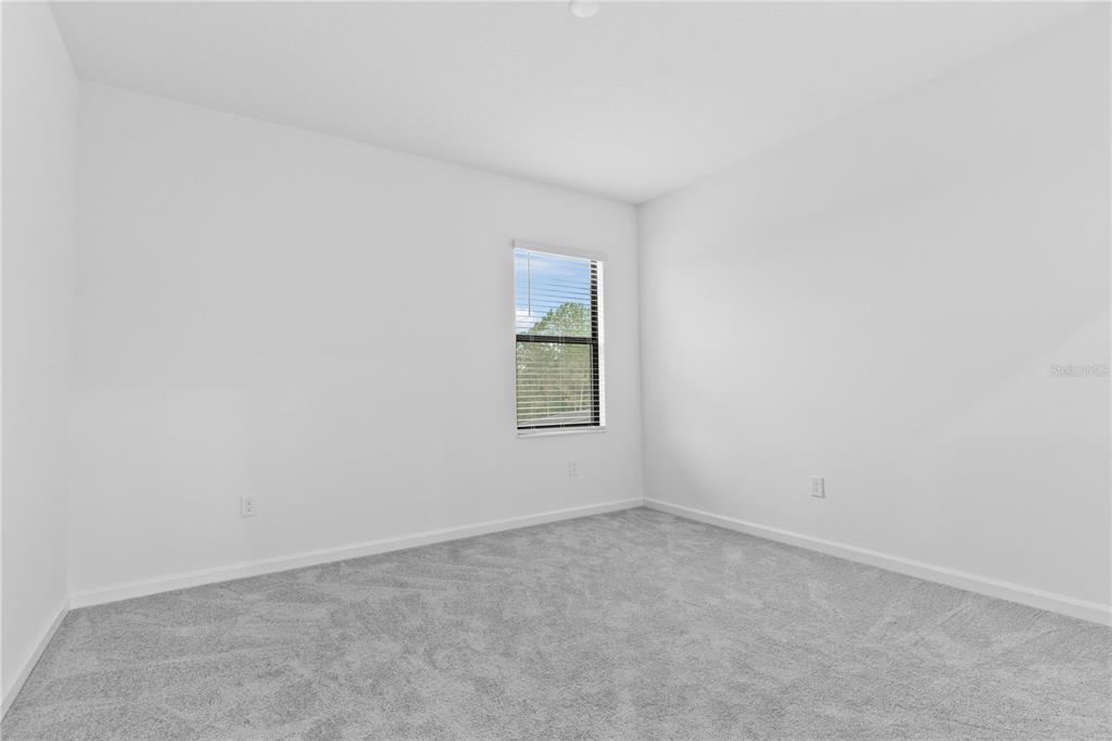 1205 Butterfly Orchid Road Davenport, FL 33837 - Photo 28 of 69 an empty room with a window