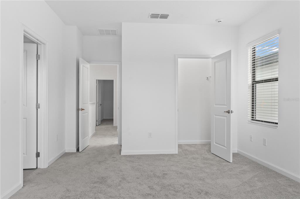 1205 Butterfly Orchid Road Davenport, FL 33837 - Photo 33 of 69 a view of an empty room with closet and a window