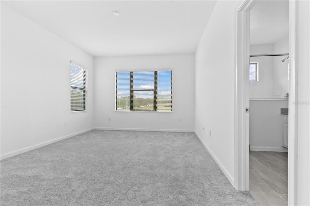 1205 Butterfly Orchid Road Davenport, FL 33837 - Photo 35 of 69 an empty room with windows and closet