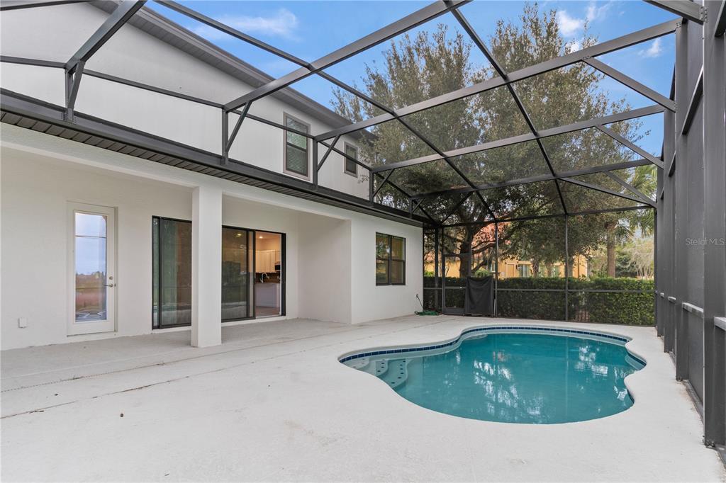 1205 Butterfly Orchid Road Davenport, FL 33837 - Photo 48 of 69 a view of a house with a backyard