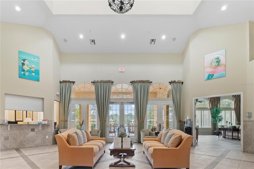 1205 Butterfly Orchid Road Davenport, FL 33837 - Photo 66 of 69 a living room with furniture and floor to ceiling windows