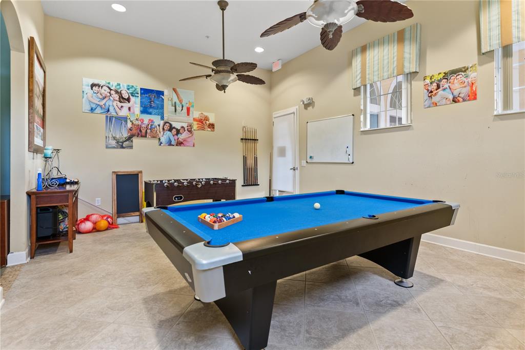 1205 Butterfly Orchid Road Davenport, FL 33837 - Photo 68 of 69 a room with pool table and paintings on the wall